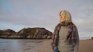 A woman walking on the beach - Cataract surgery in Belfast